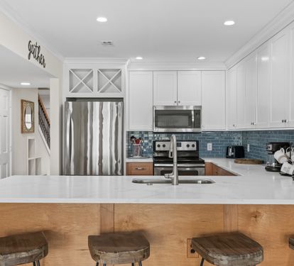 Your gourmet kitchen awaits with stainless steel appliances, granite counters, and a breakfast bar where morning coffee tastes even better.