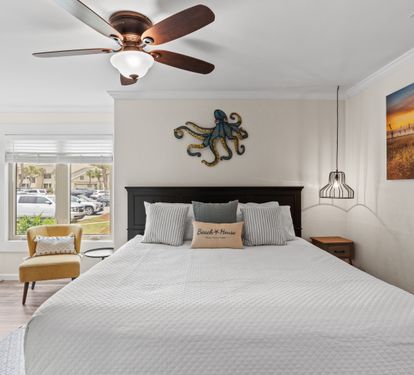 Drift off in your serene bedroom, where coastal charm meets comfort with thoughtful decor and gentle ceiling fan breezes.