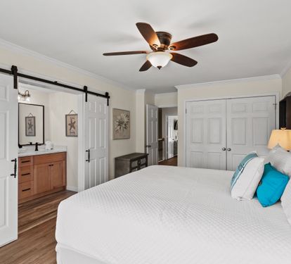 Drift into peaceful dreams in your coastal-inspired bedroom, complete with barn door charm and soothing ocean hues.