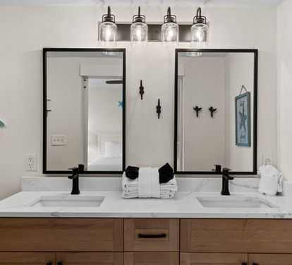 Your coastal-themed bathroom awaits with dual sinks, elegant lighting, and charming sea turtle décor—perfect for sharing your morning routine.