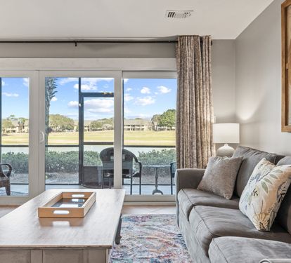 Relax with peaceful lake views and direct patio access from this bright, comfortable living space.
