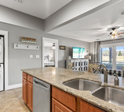 Granite kitchen with open sightlines to the living area and patio—perfect for entertaining and staying connected.