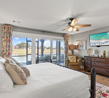 Wake up to peaceful lake views from the spacious primary suite featuring a king bed and direct patio access.