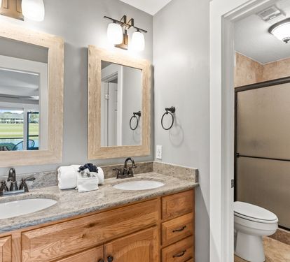Spacious primary bathroom with dual vanities and plenty of room to refresh after a day at the beach.
