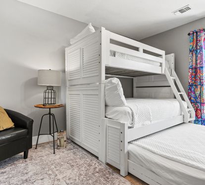 Spacious bunk room featuring a twin-over-queen bunk bed with a queen trundle—perfect for kids and extra guests.