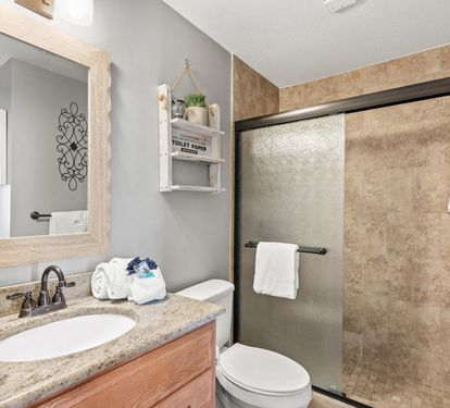 Updated guest bathroom with a walk-in shower and modern finishes for added comfort and convenience.