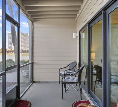 Screened patio just off the living area with comfortable seating and peaceful lake views for relaxing any time of day.