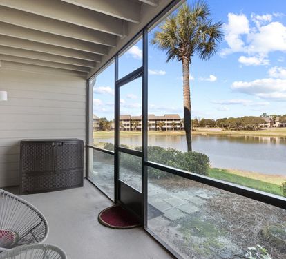Private screened patio with peaceful lake views—perfect for morning coffee, evening drinks, and relaxing outdoors.