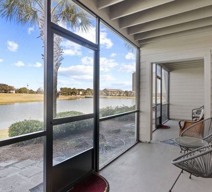 Private screened patio with peaceful golf course and lake views—perfect for relaxing morning coffee or sunset unwinding.