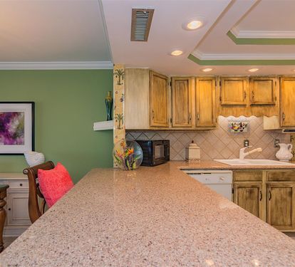 Your fully-equipped kitchen features granite counters, warm wood cabinets, and everything needed to create memorable meals during your stay.