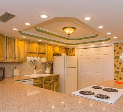 Your spacious kitchen features warm wood cabinets, granite counters, and everything needed to prepare meals during your stay.