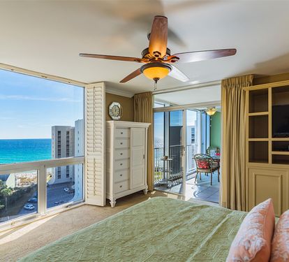 Wake up to stunning ocean views from your coastal bedroom, where turquoise waters stretch endlessly beyond your balcony doors.