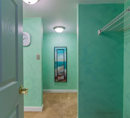 Your private laundry space features calming turquoise walls and convenient storage to keep your vacation wardrobe fresh.