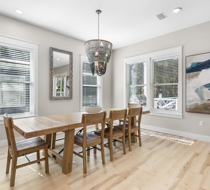Your elegant dining space features a warm wood table for six under a stunning chandelier, perfect for memorable meals together.