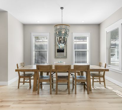 Gather around your spacious dining table where natural light streams through beautiful windows, creating the perfect setting for memorable meals together.