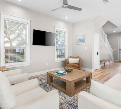 Unwind in your bright, airy living room with plush seating and modern entertainment setup for perfect relaxation.