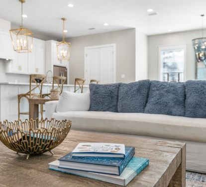 Sink into plush cushions in this bright open living space where kitchen and lounge flow together seamlessly for your perfect gathering spot.