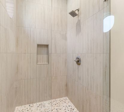 Step into your private oasis with elegant tiled walls and a refreshing rainfall shower to wash away the day.