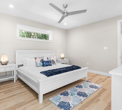 Rest peacefully in your bright, airy bedroom with crisp white linens and coastal touches that invite sweet dreams.