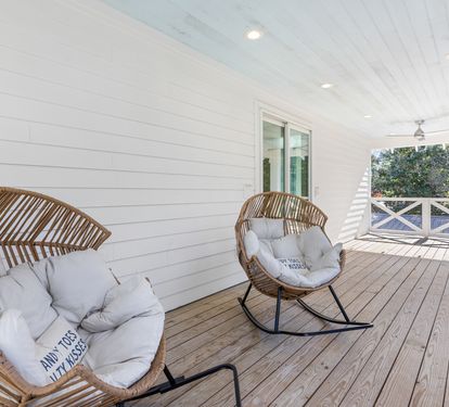 Sink into plush wicker chairs on your private covered deck, where afternoon breezes and leafy views create the perfect spot for morning coffee.