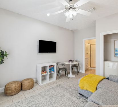 Living Area - Offering a Mini Fridge, Flat-Screen TV & Dining for 2!
