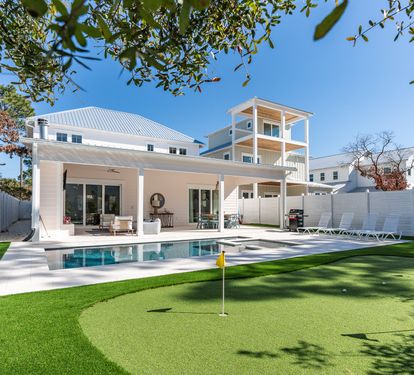 Modern coastal retreat with private pool, putting green, and covered patio for ultimate relaxation.