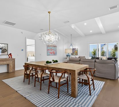 Your spacious living and dining area flows beautifully with natural light streaming through large windows, perfect for memorable meals and relaxing evenings.