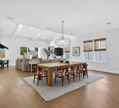 Unwind in this stunning open-concept space where natural light floods your dining and living areas through oversized windows.