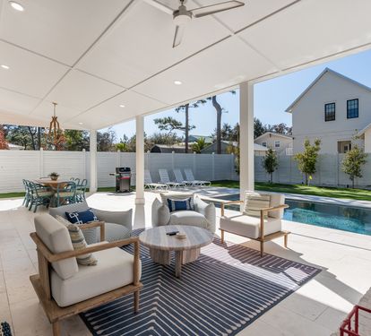 Your covered patio invites relaxation with plush seating and pool views, perfect for morning coffee or evening gatherings.