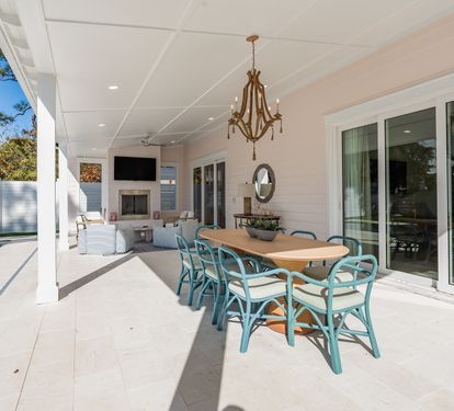 Relax under your covered terrace with elegant dining for eight, overlooking the sparkling pool and peaceful garden views.