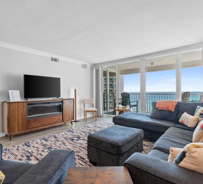Unwind in your elegant living room with stunning ocean views through floor-to-ceiling windows. Sink into the plush sectional and enjoy your perfect coastal retreat.