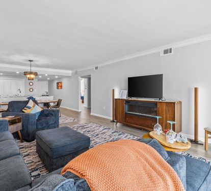 Sink into plush navy sofas and unwind in your spacious living area, complete with modern entertainment and an open kitchen for effortless gatherings.