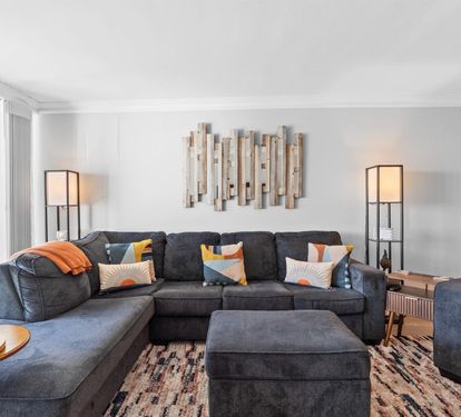 Sink into plush sectional seating with vibrant pillows, perfect for movie nights or morning coffee in your stylish retreat.