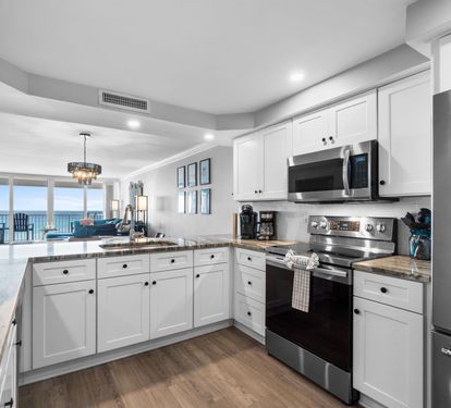 Your fully-equipped kitchen features granite counters, stainless appliances, and stunning ocean views while you cook.