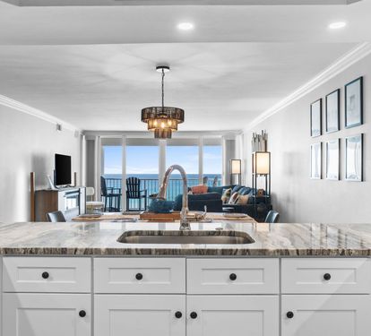 Your kitchen island offers stunning ocean views while you cook, creating a seamless flow into the elegant living space.