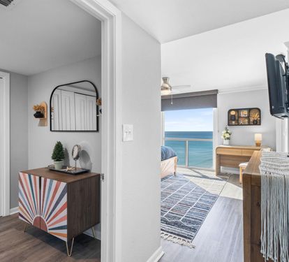 Step into your stylish coastal retreat where modern comfort meets breathtaking ocean views through every window.