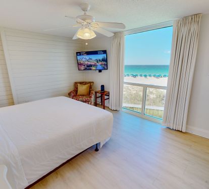 Wake up to stunning turquoise waters framed by your private window. Crisp white linens and beachy accents create your perfect coastal retreat.