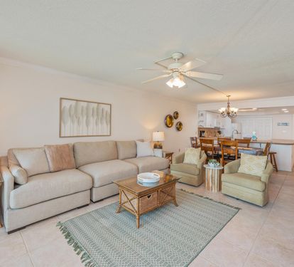 Unwind in this spacious, light-filled living room with plush sectional seating and open-concept design flowing seamlessly to your fully equipped kitchen.