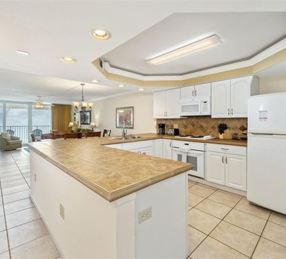 Cook with confidence in your spacious kitchen featuring granite counters and modern appliances, with stunning ocean views as your backdrop.