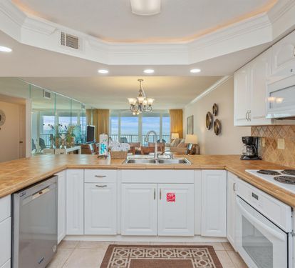 Your spacious kitchen opens to stunning ocean views, featuring modern appliances and elegant finishes for memorable vacation meals.