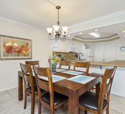 Gather around your elegant dining table for memorable meals, with a spacious kitchen just steps away for easy entertaining.