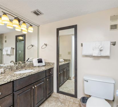 Your spacious master bathroom features elegant granite counters, dual vanities, and a luxurious walk-in shower with beautiful stone tilework.