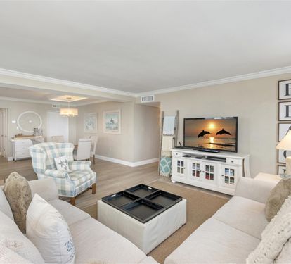 Sink into plush sofas and unwind in your elegantly appointed living space, where coastal charm meets modern comfort for perfect relaxation.