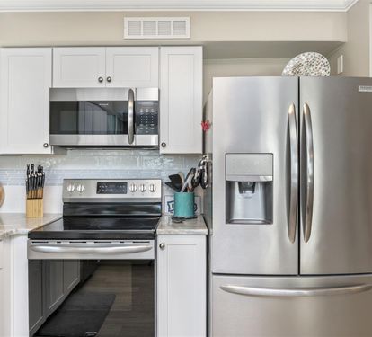 Your fully equipped kitchen features stainless steel appliances and bright white cabinetry, perfect for preparing meals during your stay.