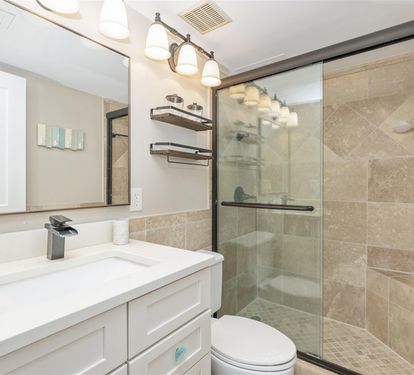Your modern bathroom features elegant marble-tiled shower, sleek vanity, and stylish lighting for ultimate comfort and relaxation.