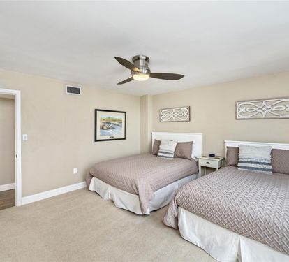 Sleep soundly in your spacious twin bedroom with plush quilted bedding and gentle ceiling fan keeping you cool.