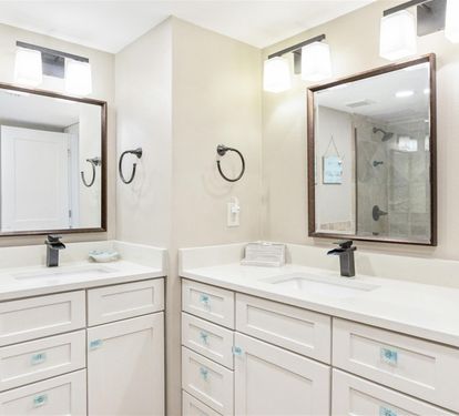 Refresh in your spacious dual-vanity bathroom with marble counters, elegant mirrors, and modern fixtures designed for comfort.