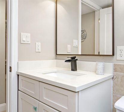 Your bright bathroom features modern fixtures and pristine white vanity with ample counter space for all your essentials.