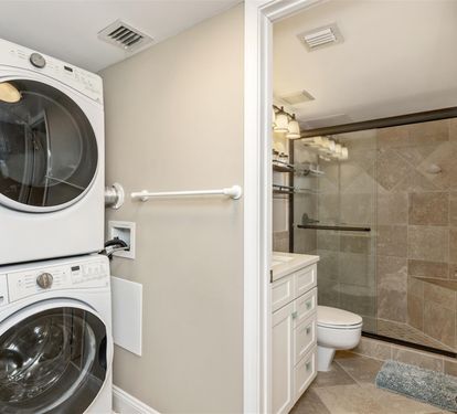 Your own in-suite washer and dryer make extended stays effortless, while the elegant bathroom features modern finishes and a spacious glass shower.