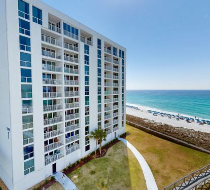 Modern beachfront resort building offers direct access to pristine white sand beaches and turquoise waters.